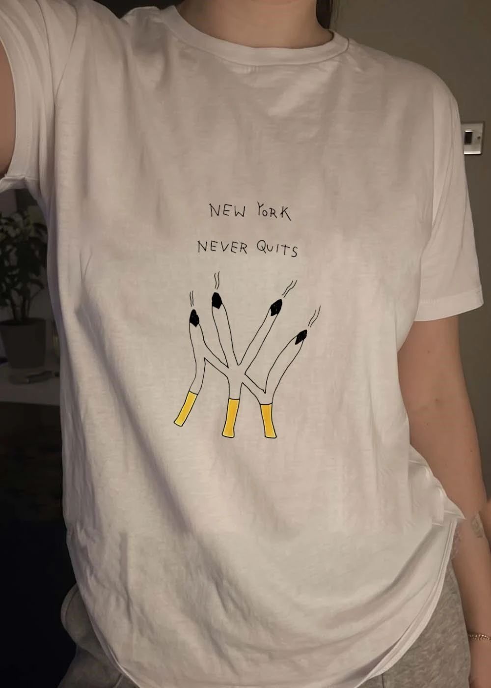 New York Never Quits Cigarettes Smoking White Graphic T-Shirt